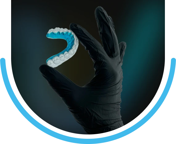 A Clear Fusion Everlast Retainer held in a gloved hand