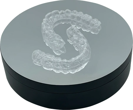 Oops Aligners arranged on a display stand